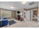 Cozy bonus room with carpet, entertainment center, and a comfy blue sofa at 428 Winecoff Woods Nw Dr, Concord, NC 28027