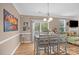 Cozy dining area with ample seating, a modern chandelier, and large windows, perfect for Gathering meals at 428 Winecoff Woods Nw Dr, Concord, NC 28027