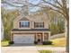 Charming two-story home with stone accents, a two-car garage, manicured lawn, and inviting curb appeal at 428 Winecoff Woods Nw Dr, Concord, NC 28027