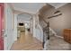 Elegant foyer featuring hardwood floors, staircase with wooden banister, and an arched entryway to the living area at 428 Winecoff Woods Nw Dr, Concord, NC 28027