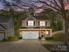 Inviting two-story home with stone accents and a well-manicured front yard at 428 Winecoff Woods Nw Dr, Concord, NC 28027