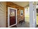 Inviting front porch with stone accents, a cozy bench, and stylish decor, perfect for relaxing at 428 Winecoff Woods Nw Dr, Concord, NC 28027