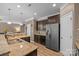 Charming kitchen features stainless steel appliances, granite countertops, and ample dark wood cabinetry at 428 Winecoff Woods Nw Dr, Concord, NC 28027