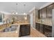Stylish kitchen with granite countertops, stainless steel sink, dark wood cabinets and eat-in breakfast bar at 428 Winecoff Woods Nw Dr, Concord, NC 28027