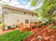 A view of the backyard with a wood deck, mulch, and grass at 431 Harvest Ter, Lake Wylie, SC 29710