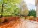 A view of the wooden deck with a wooden railing in the backyard at 431 Harvest Ter, Lake Wylie, SC 29710