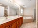 Bathroom vanity with double sinks, tile floor, garden tub, and shower with glass door at 431 Harvest Ter, Lake Wylie, SC 29710