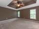 Spacious bedroom with neutral paint, carpet, ceiling fan, and two windows providing lots of natural light at 431 Harvest Ter, Lake Wylie, SC 29710