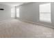 Spacious bedroom with neutral carpet, three windows offering natural light, and walls painted in a neutral color at 431 Harvest Ter, Lake Wylie, SC 29710