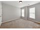 Bedroom with neutral paint and carpet, ceiling fan, and two windows providing lots of natural light at 431 Harvest Ter, Lake Wylie, SC 29710