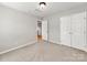 Bedroom with neutral paint and carpet, ceiling fan, closet, and doorway at 431 Harvest Ter, Lake Wylie, SC 29710