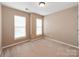 Bedroom with neutral paint, carpet, ceiling fan, and two windows at 431 Harvest Ter, Lake Wylie, SC 29710