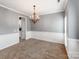 Dining room featuring gray walls, white wainscoting, carpet flooring, and an elegant chandelier at 431 Harvest Ter, Lake Wylie, SC 29710