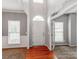 Open foyer with hardwood floors, arched doorway, and ample natural light streaming through the front windows at 431 Harvest Ter, Lake Wylie, SC 29710