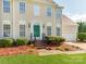 Inviting front exterior with a green front door, detailed trim, and a manicured landscape with shrubs and pine straw at 431 Harvest Ter, Lake Wylie, SC 29710