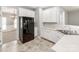 Bright kitchen showcasing white cabinets, stainless steel sink, and black refrigerator at 431 Harvest Ter, Lake Wylie, SC 29710