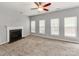 Comfortable living room with a fireplace, neutral carpeting, ample natural light, and a ceiling fan at 431 Harvest Ter, Lake Wylie, SC 29710