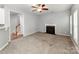Cozy living room with gray walls, neutral carpet, a fireplace, and a ceiling fan, creating a relaxing atmosphere at 431 Harvest Ter, Lake Wylie, SC 29710