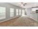 Inviting living room featuring neutral walls, carpet, and bright, natural light from large windows at 431 Harvest Ter, Lake Wylie, SC 29710