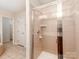 Bathroom tile shower with glass doors, shower head and controls, and tiled shelf at 431 Harvest Ter, Lake Wylie, SC 29710