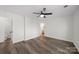 Spacious bedroom showcases modern ceiling fan, gray wood-look flooring, and ensuite bathroom at 4700 Aldersbrook Dr, Monroe, NC 28110