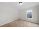 This bedroom features neutral walls, carpeted floors, and one window at 4700 Aldersbrook Dr, Monroe, NC 28110