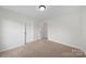 This carpeted bedroom offers neutral walls, two doors, and is move-in ready for you at 4700 Aldersbrook Dr, Monroe, NC 28110
