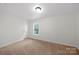 This bedroom features neutral walls, carpeted floors, and one window at 4700 Aldersbrook Dr, Monroe, NC 28110