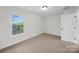 Cozy bedroom featuring a large window, neutral carpeting, and natural lighting at 4700 Aldersbrook Dr, Monroe, NC 28110