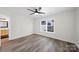 Inviting bedroom features gray flooring, neutral walls, a ceiling fan and natural light at 4700 Aldersbrook Dr, Monroe, NC 28110