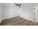 Bright bedroom features modern ceiling fan, grey wood-look flooring, and fresh neutral paint at 4700 Aldersbrook Dr, Monroe, NC 28110