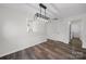 Bright dining area featuring modern light fixtures, wood-look floors, and passage to the laundry room at 4700 Aldersbrook Dr, Monroe, NC 28110