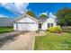 Charming single-story home with manicured lawn, well-kept landscaping, and an attached two-car garage at 4700 Aldersbrook Dr, Monroe, NC 28110
