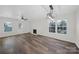 Modern living room with wood-look floors, fireplace, recessed lighting, windows, and a ceiling fan at 4700 Aldersbrook Dr, Monroe, NC 28110