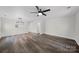Spacious living room boasts hardwood floors, and a modern ceiling fan at 4700 Aldersbrook Dr, Monroe, NC 28110