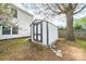 White shed with black trim and double doors located in backyard at 4700 Aldersbrook Dr, Monroe, NC 28110