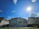 View of home's backyard on a sunny day showing the lawn, fence, and blue sky at 5025 Wicklow Dr, Gastonia, NC 28054