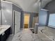 Modern bathroom featuring a double vanity with tub and shower, and marble-look tile floor at 5025 Wicklow Dr, Gastonia, NC 28054