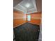 Bright bedroom features tray ceiling, gray carpet, with orange and white accent wall at 5025 Wicklow Dr, Gastonia, NC 28054