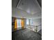 Bright bonus room featuring plush carpet, large window with elegant curtains, and a view of the staircase at 5025 Wicklow Dr, Gastonia, NC 28054