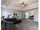 Large bonus room featuring high ceilings, an exercise bike, and a plush, black sectional couch at 5025 Wicklow Dr, Gastonia, NC 28054