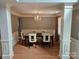 Dining room with hardwood floors, white trim, wainscoting and an elegant chandelier at 5025 Wicklow Dr, Gastonia, NC 28054