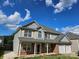 Charming two-story home featuring a two-car garage and a combination of vinyl siding and brick accents at 5025 Wicklow Dr, Gastonia, NC 28054