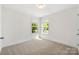 Bedroom boasts two windows offering natural light, neutral carpet, and white trim at 505 E Robinson St, Dallas, NC 28034