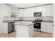Modern kitchen features white cabinets, granite countertops, stainless steel appliances, and a kitchen island at 505 E Robinson St, Dallas, NC 28034