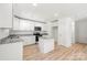 Modern kitchen features white cabinets, granite countertops, stainless steel appliances, and a kitchen island at 505 E Robinson St, Dallas, NC 28034