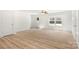 Bright living room features wood-look flooring, neutral walls, a ceiling fan, and ample natural light from the windows at 505 E Robinson St, Dallas, NC 28034