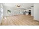 Open-concept living room flows into the kitchen featuring wood-look flooring, neutral walls, and ample natural light at 505 E Robinson St, Dallas, NC 28034