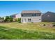 View of the home's back exterior and sprawling yard with mature trees and landscaping at 5102 Candleglow Ct, Indian Trail, NC 28079