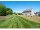 Expansive backyard offers a meticulously kept lawn and privacy with mature trees at 5102 Candleglow Ct, Indian Trail, NC 28079